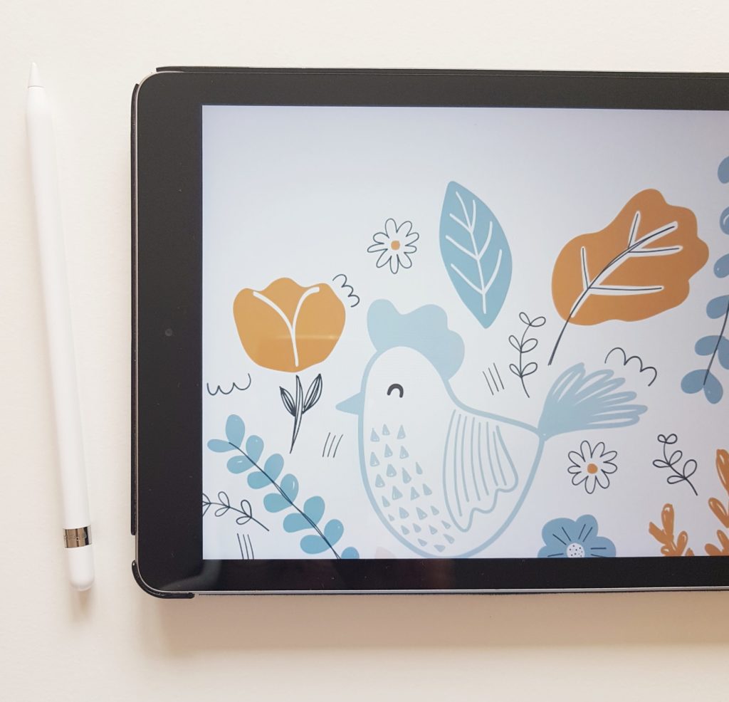 Flatlay of an ipad with a cute chicken illustration on it
