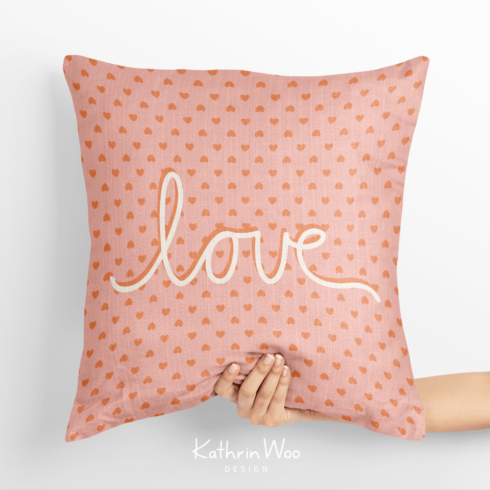 Hearts pattern with text overlay LOVE on a pillow from the Bloom And Grow collection by Kathrin Woo