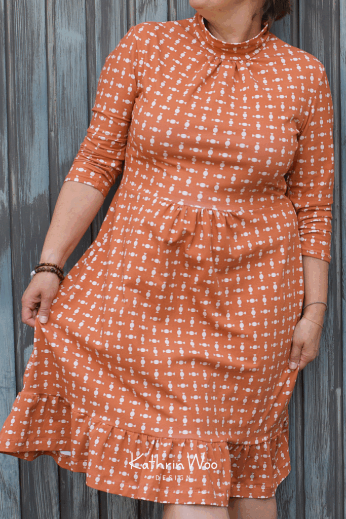 Graphic geometric Halloween surface pattern design Candy from Kathrin Woo's Halloween Collection Spooky Season displayed on a dress made with fabric from Lillestoff