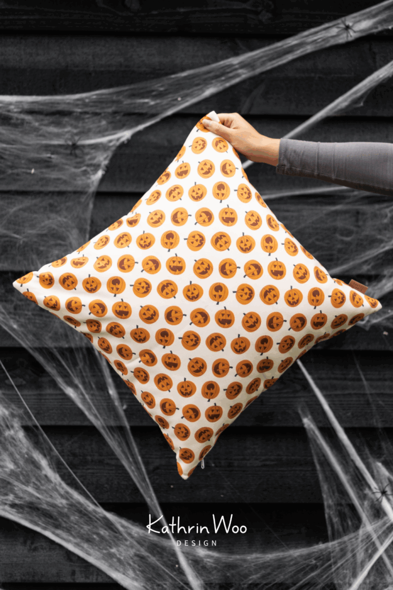 Halloween Surface Pattern Design Pumpkin Polka Dot by Kathrin Woo showcased on a pillow case