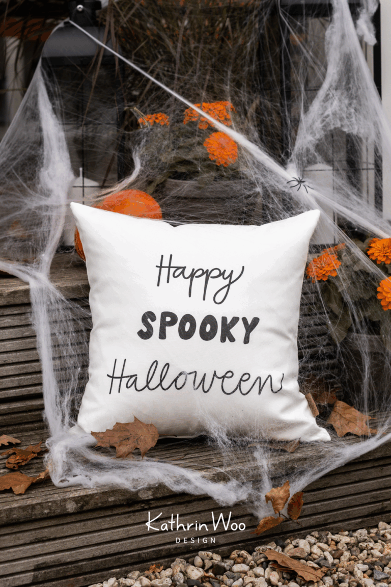 Halloween Typography Happy Spooky Halloween by Kathrin Woo showcased on a pillow case