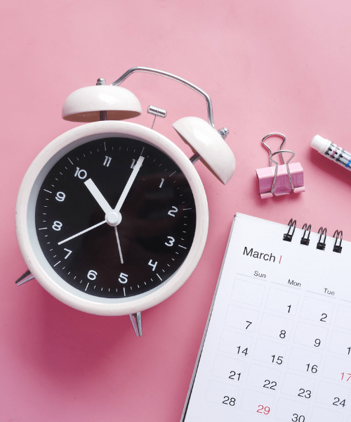 Alarm clock and calendar, symbolizing planning your year as a creative entrepreneur.